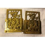 A pair of brass bookends with dragon design