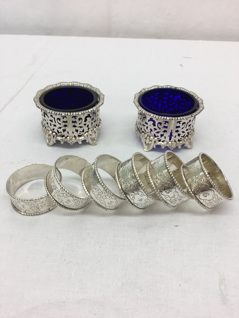 A pair of HM silver-plated salts with blue liners;