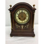 A mahogany inlaid mantel clock