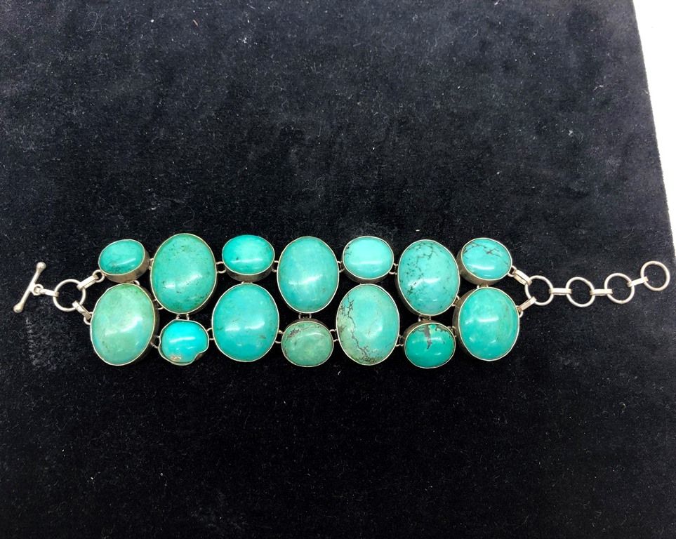 A large turquoise beaded silver bracelet