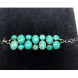 A large turquoise beaded silver bracelet