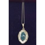 A silver diamond and blue diamond pendant
