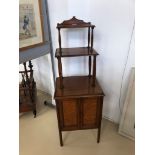 A mahogany cabinet with tiered top
