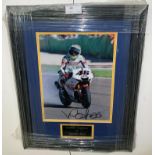 A framed & glazed signed photograph of Valentino Rossi with COA