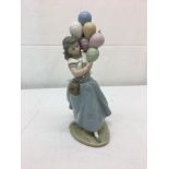 A Lladro figure of a girl with balloon