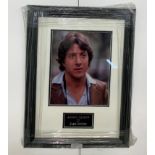 A framed & glazed signed photograph of Dustin Hoffman with COA