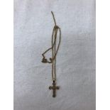 An unmarked gold and diamond crucifix on a 9ct chain