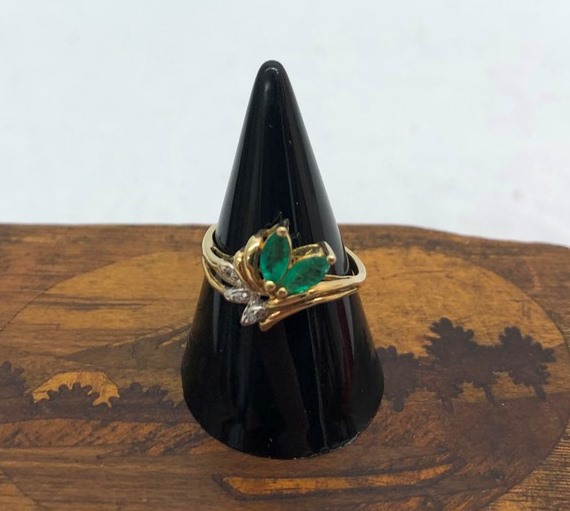 A 10k emerald and diamond ring