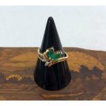 A 10k emerald and diamond ring