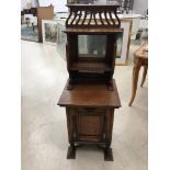 An Art Nouveau oak coal box with mirrored back