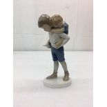A Bing & Grondhal figure of a boy and girl riding piggyback