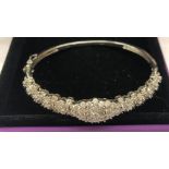 A sterling silver bangle set with 5 ct of diamonds