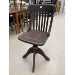 A 1920s oak swivel office chair