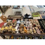 A large collection of teddy bears and soft toys