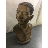 A large wooden bust of an African elder by Norman Chapotrera