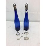 A pair of blue glass silver-topped Victorian bottles;