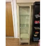 An upright glass display cabinet