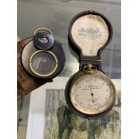 A 19th century cased pocket barometer together with a compass enclosed in a leather case