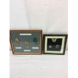 Two sets of framed Russian cap badges