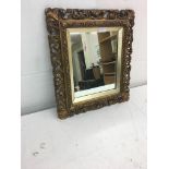 A gilt-framed mirror