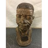 A small wooden bust of an African elder by Norman Chapotrera