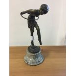 An Art Deco-style bronze woman and hoop