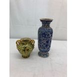 A terracotta painted vase in blues and white;