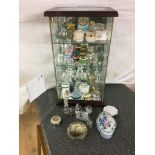 A glass cabinet with curios