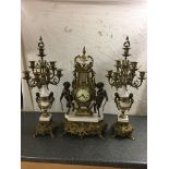 A large brass clock garniture