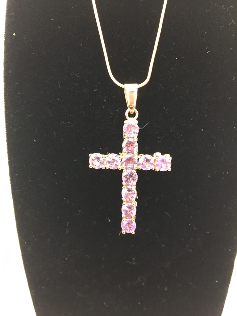 A new silver Aguilera Tudor rose cross in rose gold plate with amethyst