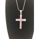 A new silver Aguilera Tudor rose cross in rose gold plate with amethyst