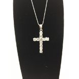 A new Aguilera silver cross and white topaz