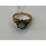 A 9ct gold diamond and emerald dress ring