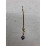 A diamond and blue stone pendant on a 9ct chain