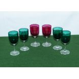 Four green and two cranberry glasses