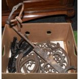 A box of cast iron items, horse shoes and flat irons