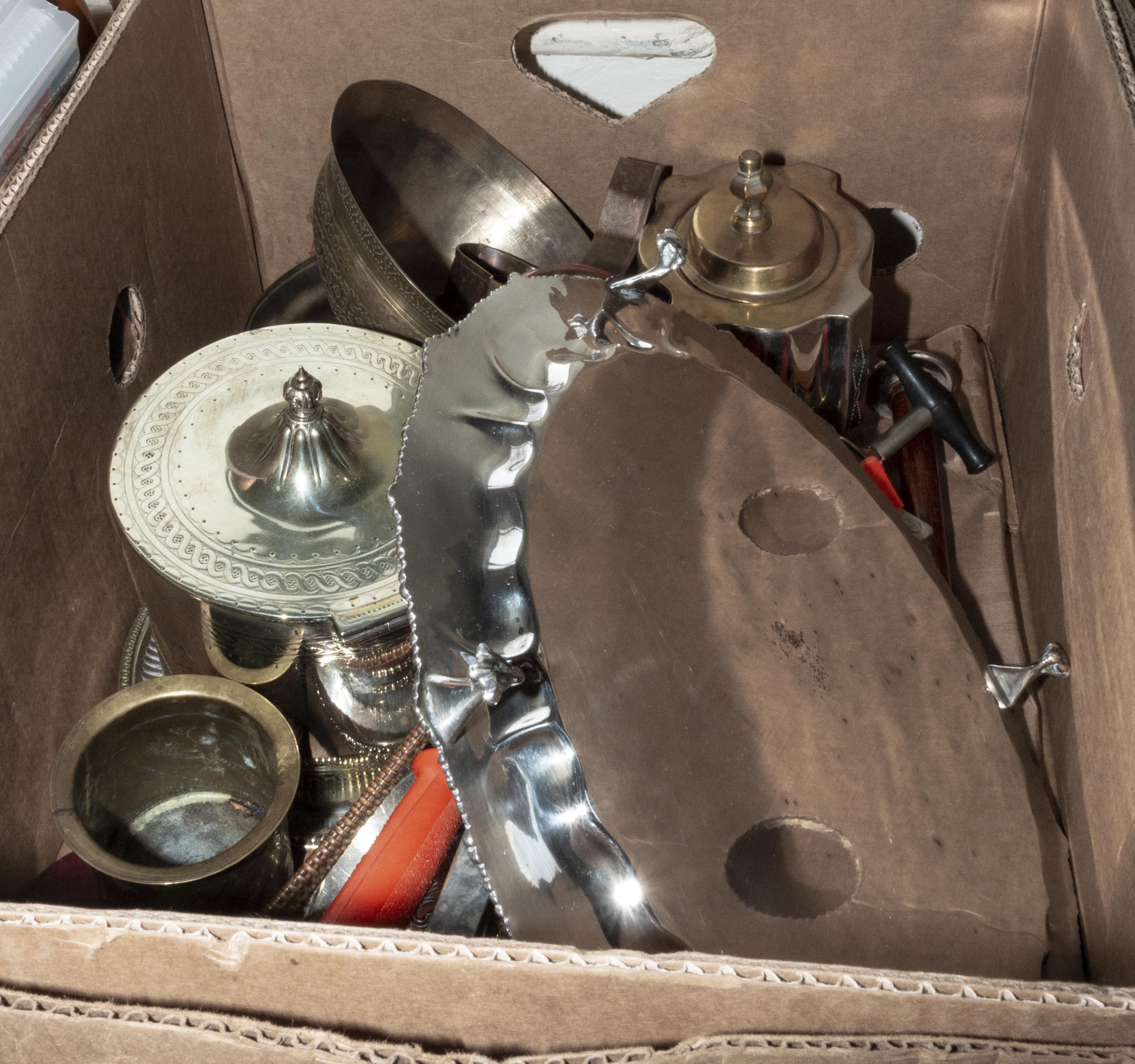 A box containing metal ware