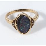 An 18ct gold ring set with an opal doublet and diamonds, size N