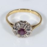 An 18ct gold ruby and diamond cluster ring, size N