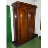 A Victorian two door mahogany wardrobe with fitted interior.