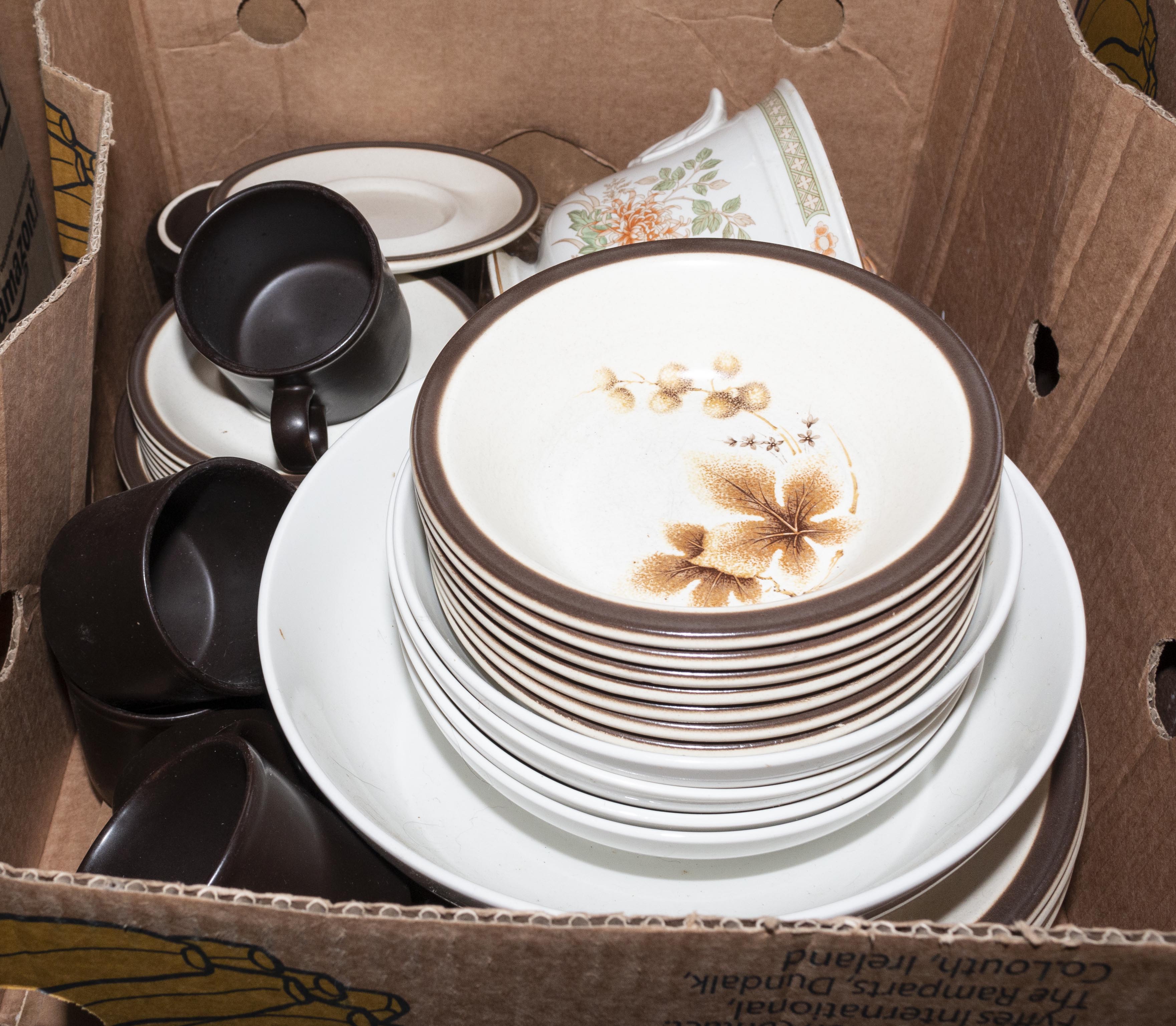 A box containing pottery dinner and tea ware