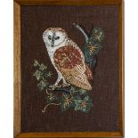 A framed embroidery depicting an owl