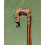 A wood crook with thistle handle together with a buffalo horn crook