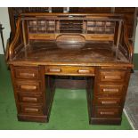 An oak roll top desk with all round fielded panels complete with all drawers kick and slides, and