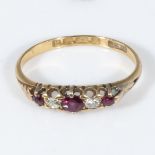 An 18ct gold ring set with three rubies and diamonds, size L