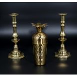 A pair of brass candlesticks and a retro cocktail shaker