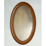 An oval wall mirror