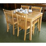 A pine kitchen table and four chairs