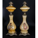 A pair of Edwardian glass and ormolu oil lamps