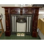 A reproduction mahogany fire surround with cast iron insert and decorative tiles
